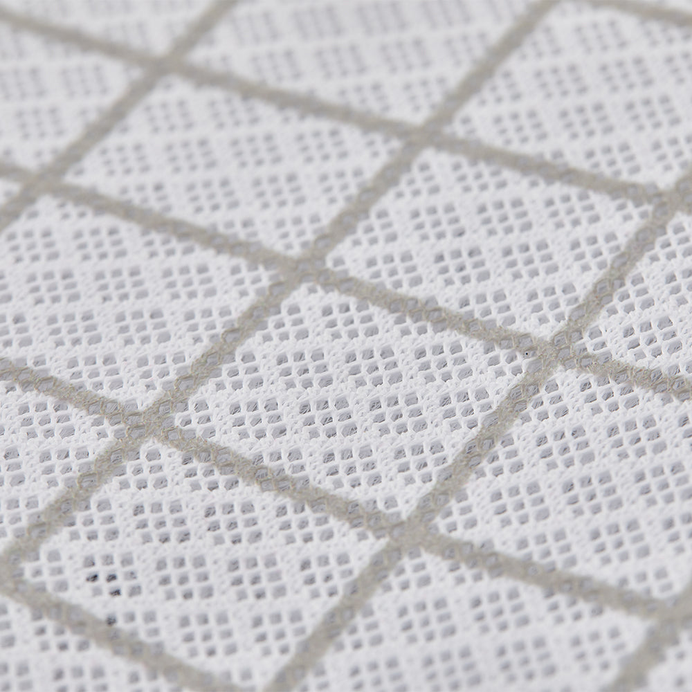 Close-up of a textured white fabric with a diamond pattern